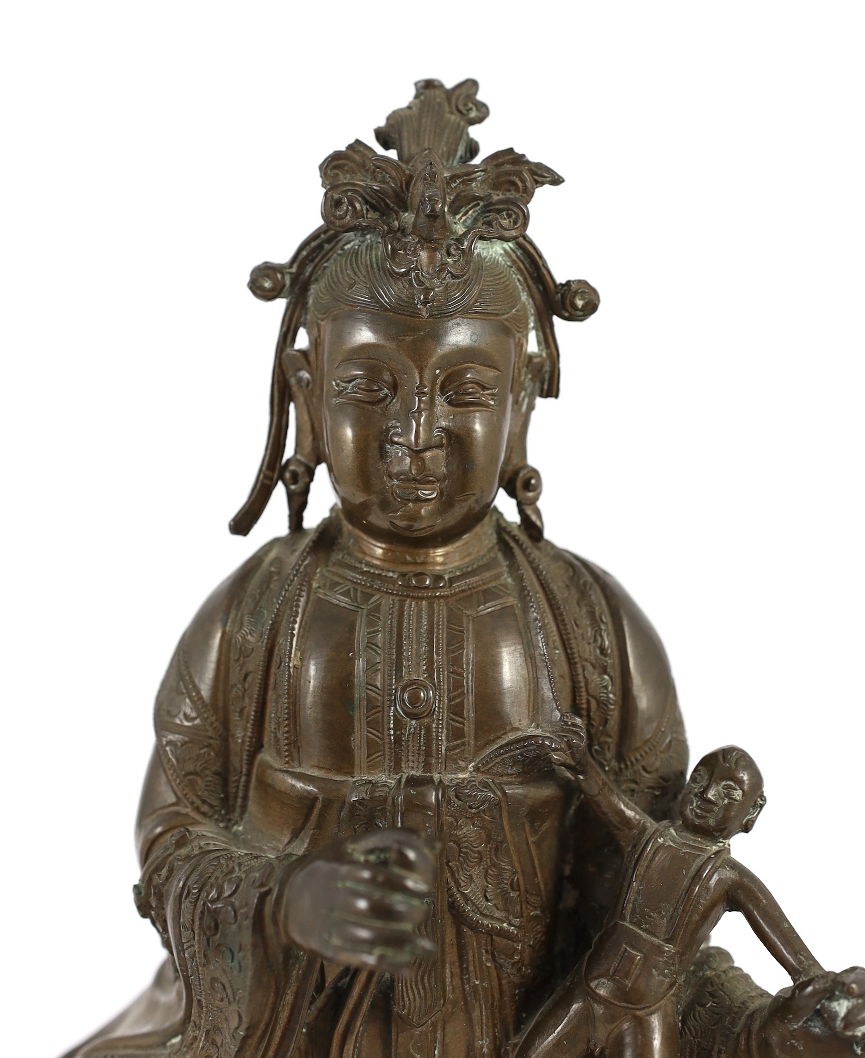 A large Chinese bronze group of Xi Wangmu and a child, late Ming dynasty, 31.5cm high excluding later wood stand